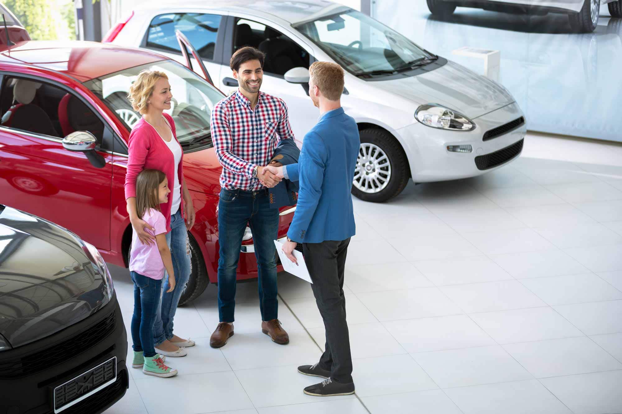 Auto Dealer Making A Sale